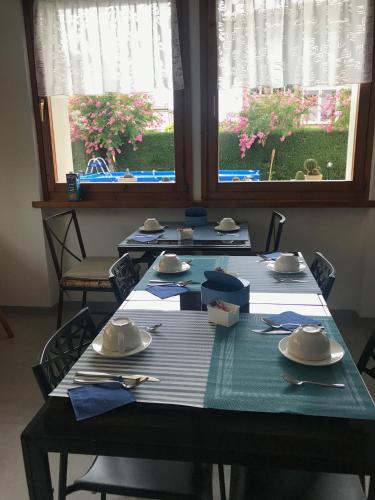 a table with plates and napkins on top at Il Sole e la Luna B&B in Garda in Garda