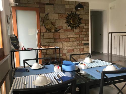 a dining room with a table and chairs and a brick wall at Il Sole e la Luna B&B in Garda in Garda