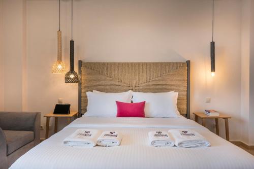 a bedroom with a bed with two towels on it at Trianon Luxury Apartments & Suites in Chania Town