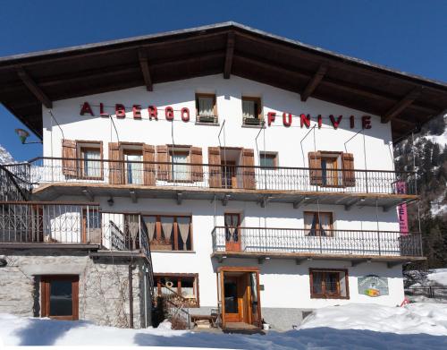 a large white building with a balcony at Hotel Funivia in Courmayeur