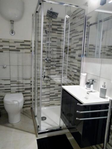 a bathroom with a shower and a sink and a toilet at La Nicuzza-#historicalhouse in Agrigento