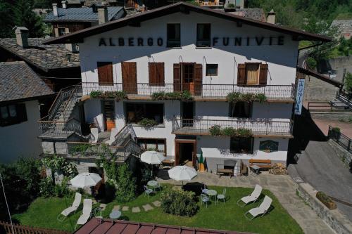 an aerial view of a hotel with tables and umbrellas at Hotel Funivia in Courmayeur