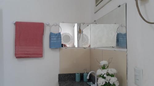 a bathroom with a towel rack and a sink at Suíte zona Sul de ilhéus próximo a praia in Ilhéus