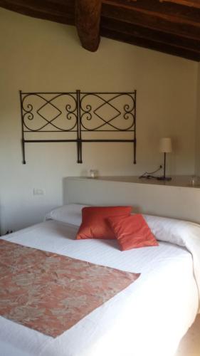 a bedroom with a large white bed with red pillows at Il Pezzatino in Rufina
