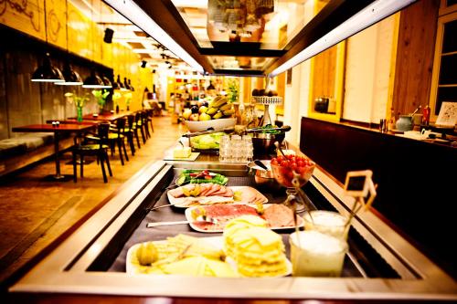 a buffet line with many different types of food at Superbude Hamburg St Pauli in Hamburg