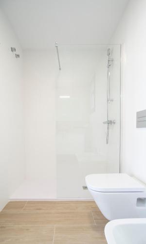 a white bathroom with a tub and a sink at Modern sea front jacuzzi Blue Sky in Alicante