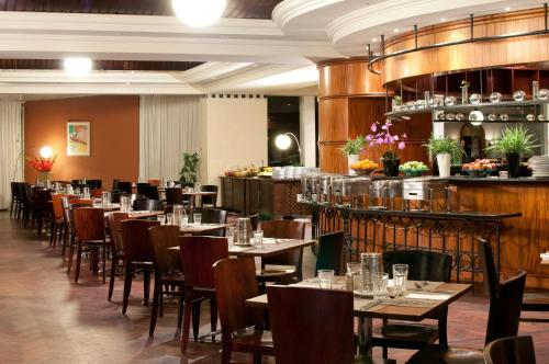 a restaurant with tables and chairs and a bar at David Dead Sea Resort & Spa in Ein Bokek