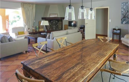 a living room with a wooden table and chairs at Beautiful Home In Pierrerue in Pierrerue