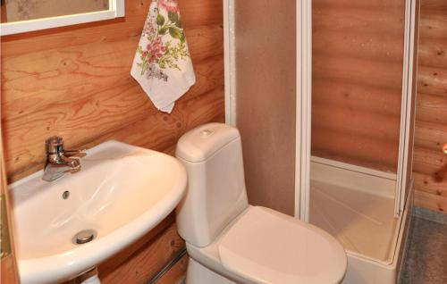 a bathroom with a toilet and a sink and a shower at 2 Bedroom Lovely Home In Sunne in Sunne