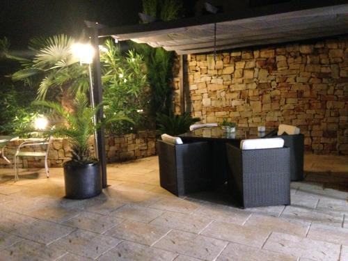 a patio with a table and chairs under an umbrella at T2 entre mer et montagne in Larressore