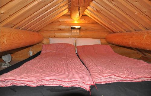 a bedroom with two beds in a wooden cabin at 2 Bedroom Lovely Home In Sunne in Sunne
