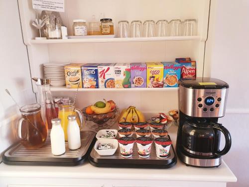 a refrigerator with a coffee maker and some food at Lyndale Guest House in Weymouth