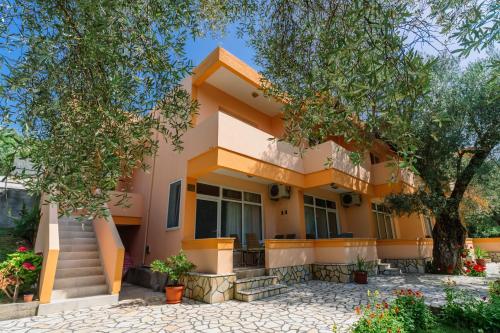 a house with a tree in front of it at Apartments Aura in Utjeha