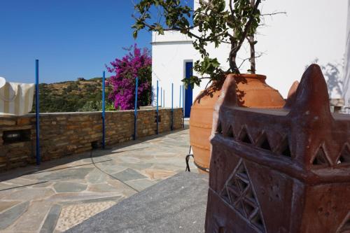 a plant in a large pot sitting on a sidewalk at AEGEAN VIEW in Kochilos