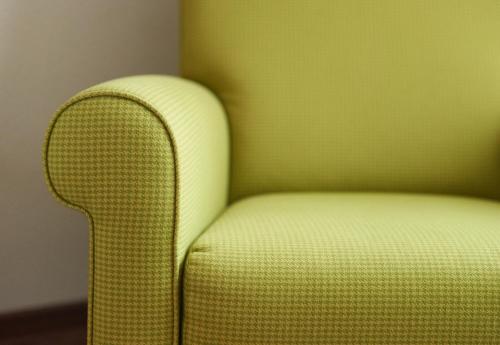 a yellow chair sitting in a corner of a room at Fetzers Landhotel in Ingelheim am Rhein