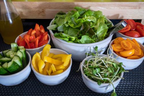 a group of bowls of vegetables on a table at Artist Hotel - an Atlas Boutique Hotel in Tel Aviv