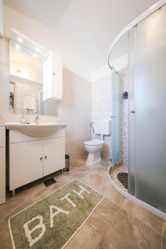 a bathroom with a sink and a toilet and a shower at Holiday Home Ana in Poljana
