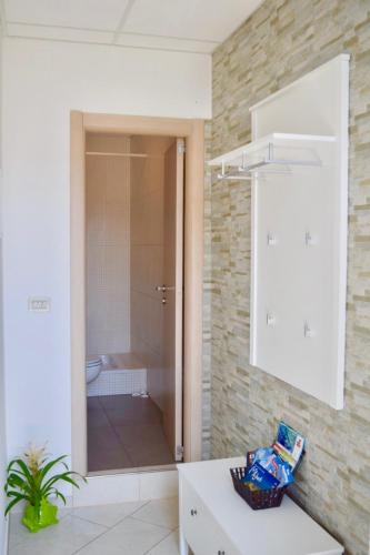 a bathroom with a sink and a toilet in a room at Apartman Pia in Cavtat