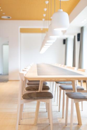 a wooden table with chairs and a dining room at Mari Pop Hotel in Ried im Zillertal