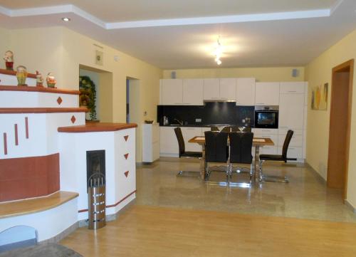 a kitchen and dining room with a table and chairs at Appartementhaus Freiler in Mörbisch am See