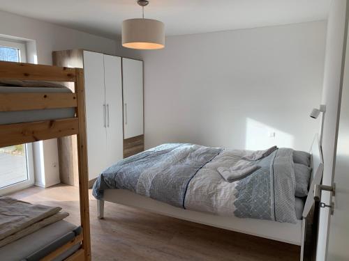 a bedroom with a bed and a bunk bed at Forest View Apartments in Winterberg Sauerland in Medebach