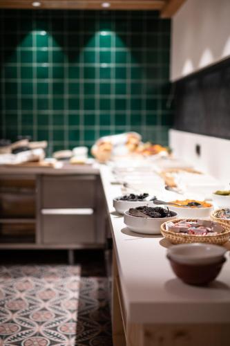 a kitchen with several bowls of food on a counter at Mari Pop Hotel in Ried im Zillertal