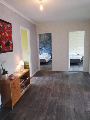 a large living room with two beds and a table at Gästhuset 32 in Vansbro