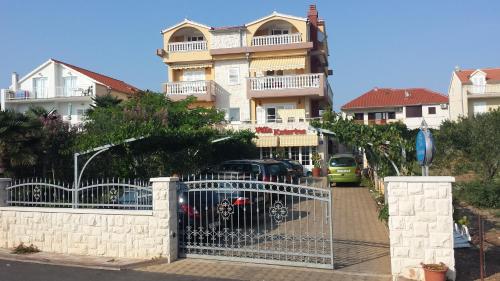 a gate with a car parked in front of a building at Villa Katarina in Srima