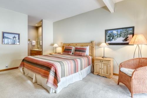 a bedroom with a large bed and a chair at Meadow House 15 | Discover Sunriver in Sunriver