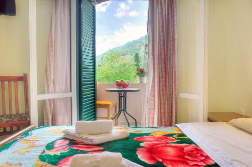 a bedroom with a window and a bed with towels on it at Delphi in Agios Gordios