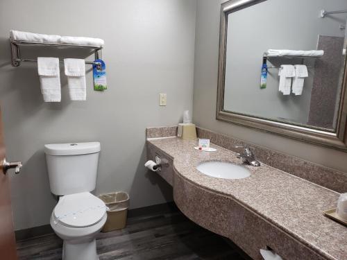 A bathroom at Days Inn & Suites by Wyndham Cleburne TX