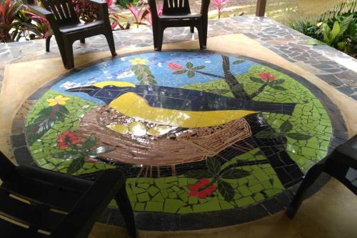 a mosaic table with a bird on top of it at Tower Studio in the Treetops in Altos del Maria Panama in El Picacho