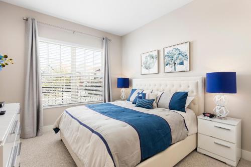 a bedroom with a large bed and a window at 5min Disney Fantastic Townhome, BBQ 116 in Orlando