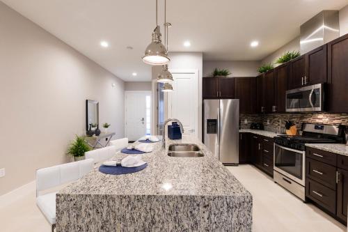 a kitchen with a large island in the middle at 5min Disney Fantastic Townhome, BBQ 116 in Orlando