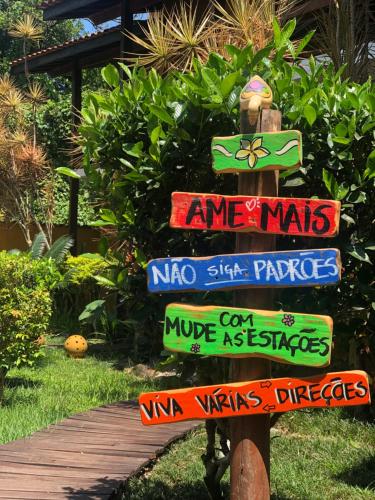 a street sign with many different signs on it at Pousada In Bali - Maresias in Maresias