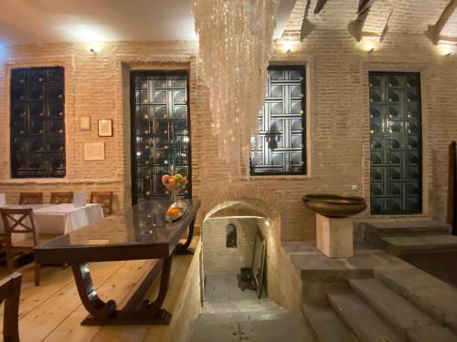 a dining room with a table and a fireplace at Castle in Old Town in Tbilisi City