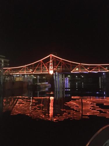 a bridge in the water at night at Hospedaje “ El Segoviano “ in Carmelo