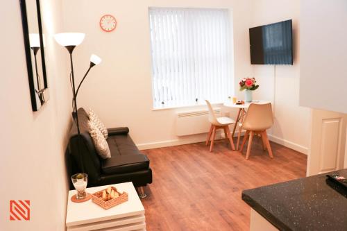 a living room with a couch and a table at Modern Newgate Apartments - Convenient Location, Close to All Local Amenities in Stoke on Trent