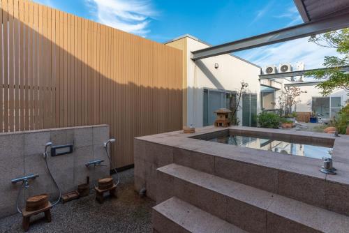 a backyard with a plunge pool and a building at Bijou Suites AI PREMIUM in Osaka