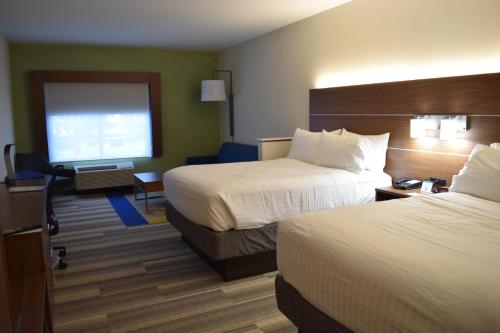 a hotel room with two beds and a television at Holiday Inn Express & Suites Ithaca by IHG in Ithaca