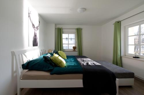 a bedroom with a bed with green curtains at Ferienwohnungen auf der Schleusenhalbinsel in Woltersdorf