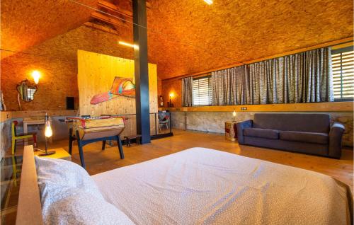 a bedroom with a bed and a couch and a table at Amazing Home In Tolmin With Sauna in Tolmin