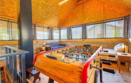a large room with a foosball table in the middle at Amazing Home In Tolmin With Sauna in Tolmin