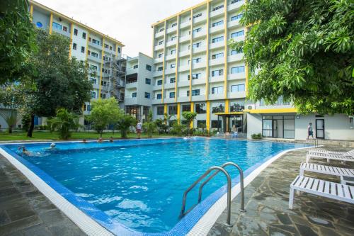 a swimming pool in front of a building at Hotel Siddhartha, Nepalgunj in Nepālganj
