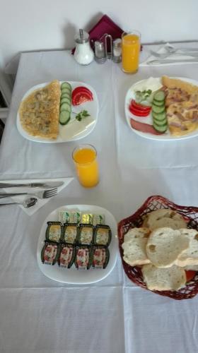 a white table with plates of food on it at Private accommodation Lidija Rakočević in Kolašin