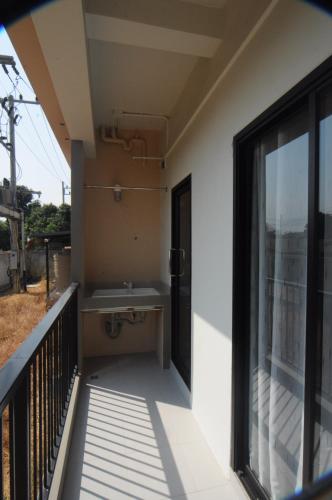 a balcony of a house with a sink at NK place Phetchaburi in Ban Nong Som