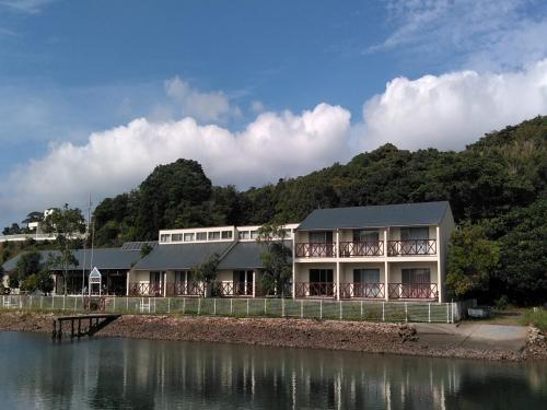 een gebouw naast een waterlichaam bij Tabist Villa Daio Resort Ise-Shima in Shima