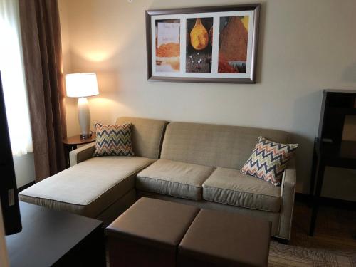 a living room with a couch and a table at Staybridge Suites Grand Rapids-Kentwood by IHG in Grand Rapids