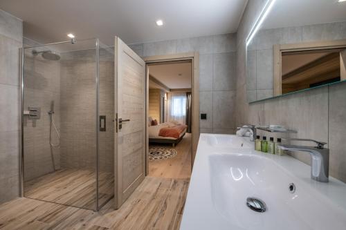 a bathroom with a bath tub and a shower at Manali Lodge by Alpine Resorts in Courchevel