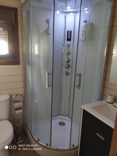 a bathroom with a shower with a toilet and a sink at Casa Ecoeficiente Eguzkilore in Torrelles